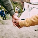 Welcoming asylum seekers holding hands.