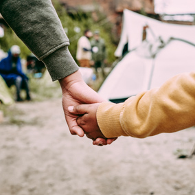 Welcoming asylum seekers holding hands.